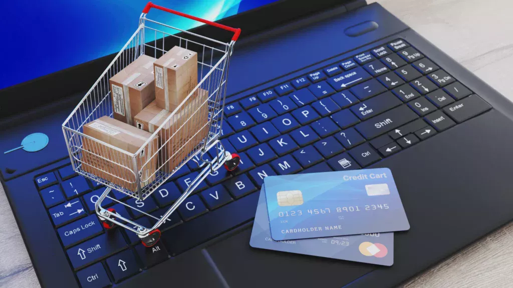 Online shopping cart and credit cards on a laptop representing the role of SEO Agencies for E-Commerce Websites.